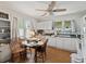 Bright eat-in kitchen features white cabinets, neutral countertop, and hardwood floors at 544 80Th N Ave, St Petersburg, FL 33702