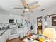 Kitchen features white cabinets, appliances, and a view into another room at 544 80Th N Ave, St Petersburg, FL 33702