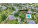Aerial view showcasing community amenities including a pool, library, and shuffleboard, surrounded by lush landscaping and residences at 5456 Fairway Bend Dr, Sarasota, FL 34243
