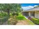 Expansive backyard featuring a well-kept lawn, lush landscaping, and comfortable seating area at 5456 Fairway Bend Dr, Sarasota, FL 34243