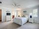 Bright bedroom with king bed, white furnishings, ceiling fan, and ample natural light at 5456 Fairway Bend Dr, Sarasota, FL 34243