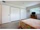 Comfortable bedroom featuring built in closets, a wicker dresser, and neutral walls with a window, providing a relaxing space at 5456 Fairway Bend Dr, Sarasota, FL 34243