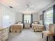 Comfortable bedroom features two twin beds, a chair, neutral walls with bright windows for a serene and peaceful ambiance at 5456 Fairway Bend Dr, Sarasota, FL 34243