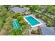 Aerial view of the community pool and shuffleboard, surrounded by lush greenery and seating at 5456 Fairway Bend Dr, Sarasota, FL 34243