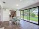 The dining area features sliding barn doors and large glass windows with garden views providing a relaxing space to dine at 5456 Fairway Bend Dr, Sarasota, FL 34243