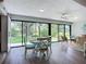 Bright dining area with large windows offering a view of the lush green lawn and landscaping at 5456 Fairway Bend Dr, Sarasota, FL 34243
