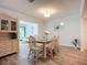 Charming dining room featuring a glass table and wicker chairs, with a view to the living room at 5456 Fairway Bend Dr, Sarasota, FL 34243