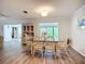 Elegant dining area with a glass table, wicker chairs, and natural light at 5456 Fairway Bend Dr, Sarasota, FL 34243