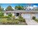 Attractive single-story home featuring a two-car garage, walkway and manicured landscaping at 5456 Fairway Bend Dr, Sarasota, FL 34243