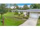 Attractive single-story home featuring a well manicured lawn and attached garage at 5456 Fairway Bend Dr, Sarasota, FL 34243
