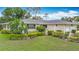 Charming single-story home featuring lush landscaping and attached two-car garage at 5456 Fairway Bend Dr, Sarasota, FL 34243