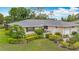 Charming single-story home featuring lush landscaping and attached two-car garage at 5456 Fairway Bend Dr, Sarasota, FL 34243