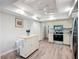 Well-lit kitchen features wood floors, island, stainless steel appliances, and granite countertops at 5456 Fairway Bend Dr, Sarasota, FL 34243