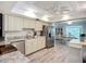 Modern kitchen flowing into the dining area, featuring stainless steel appliances and neutral cabinets at 5456 Fairway Bend Dr, Sarasota, FL 34243