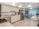 Bright kitchen with stainless steel appliances, granite countertops, and an open layout to the dining area at 5456 Fairway Bend Dr, Sarasota, FL 34243
