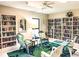 Inviting library with comfortable seating and extensive bookshelves, ideal for reading at 5456 Fairway Bend Dr, Sarasota, FL 34243