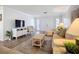 Cozy living room with comfortable seating, wicker furniture, and a large TV at 5456 Fairway Bend Dr, Sarasota, FL 34243