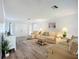 Bright living room featuring neutral furniture, wood floors, and a decorative rug at 5456 Fairway Bend Dr, Sarasota, FL 34243