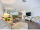 Spacious living room with neutral tones, comfortable sofas, and views of the backyard at 5456 Fairway Bend Dr, Sarasota, FL 34243