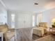 Comfortable living room with wood-look floors and light-filled windows, featuring a double-door entryway at 5456 Fairway Bend Dr, Sarasota, FL 34243