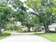 Scenic street view featuring lush trees lining the road and well-maintained homes, creating a serene neighborhood ambiance at 5456 Fairway Bend Dr, Sarasota, FL 34243