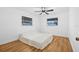Cozy bedroom featuring hardwood floors and natural light from two windows at 5734 20Th N Ave, St Petersburg, FL 33710