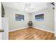Bedroom with hardwood flooring, ceiling fan, and two windows providing natural light at 5734 20Th N Ave, St Petersburg, FL 33710