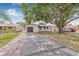 Charming single-story home featuring a well-maintained front yard and mature tree providing ample shade at 5734 20Th N Ave, St Petersburg, FL 33710