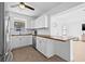 Open kitchen featuring stainless steel appliances, white cabinetry, and breakfast bar seating at 5734 20Th N Ave, St Petersburg, FL 33710