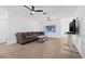 Bright and airy living room featuring tile floors, ceiling fans, and a comfortable seating arrangement at 5734 20Th N Ave, St Petersburg, FL 33710
