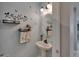Stylish powder room features floating shelves and charming decorative accents for added appeal at 5914 Goldenbark Pl, Lithia, FL 33547