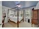 Cozy bedroom featuring a four-poster bed, windows, and a calming blue ceiling at 5914 Goldenbark Pl, Lithia, FL 33547