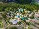Aerial view of the community pool area with multiple pools, lounge areas, and mature landscaping at 5914 Goldenbark Pl, Lithia, FL 33547