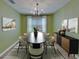 Elegant dining room features a modern chandelier, sleek furniture, and stylish decor at 5914 Goldenbark Pl, Lithia, FL 33547
