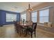 Bright dining room features a modern light fixture and a window seat at 5914 Goldenbark Pl, Lithia, FL 33547