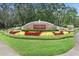 View of the FishHawk Ranch entrance sign with colorful landscaping and manicured grounds at 5914 Goldenbark Pl, Lithia, FL 33547