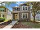 Charming two-story home featuring a bright yellow front door, manicured landscaping, and a welcoming walkway at 5914 Goldenbark Pl, Lithia, FL 33547
