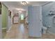 Hallway featuring tile flooring and open bathroom at 5914 Goldenbark Pl, Lithia, FL 33547