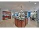 Modern kitchen island with granite countertops offering bar seating in an open-concept living space at 5914 Goldenbark Pl, Lithia, FL 33547