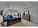 Bright main bedroom boasts tray ceiling, windows, and a large wooden dresser at 5914 Goldenbark Pl, Lithia, FL 33547