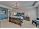 Beautiful main bedroom featuring tray ceilings, chandelier, and an accent wall at 5914 Goldenbark Pl, Lithia, FL 33547