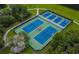 Aerial view of the community tennis courts surrounded by lush landscaping and green space at 5914 Goldenbark Pl, Lithia, FL 33547