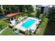 A community swimming pool surrounded by palm trees, lounge chairs and a covered shelter at 5920 80Th N St # 103, St Petersburg, FL 33709