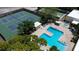 An aerial view showing a community pool, tennis courts and shuffleboard courts at 5920 80Th N St # 103, St Petersburg, FL 33709
