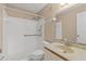 Well-lit bathroom featuring white tiled walls, a vanity with a sink, and toilet at 5920 80Th N St # 103, St Petersburg, FL 33709