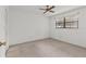 Bright bedroom features neutral carpet and natural light from the window at 5920 80Th N St # 103, St Petersburg, FL 33709