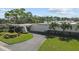 Exterior of the building with driveway, parking, green space, and trees at 5920 80Th N St # 103, St Petersburg, FL 33709