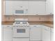 Well-lit kitchen showcasing a white gas range and ample cabinet space at 5920 80Th N St # 103, St Petersburg, FL 33709