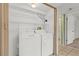 Convenient laundry room featuring a washer, dryer, and shelving for storage at 5920 80Th N St # 103, St Petersburg, FL 33709