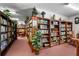 A well-stocked library with floor to ceiling shelves, reading chairs and decorative items on display at 5920 80Th N St # 103, St Petersburg, FL 33709